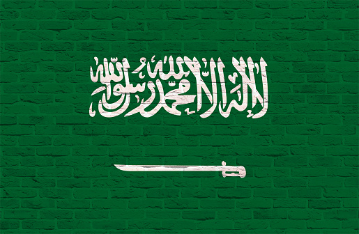 Saudi Arabian flag painted over brick wall