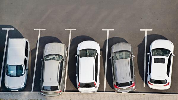 View from above of car parking full of vehicles.
