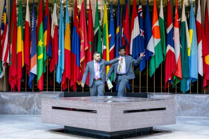 People gather outside World Bank headquarters during the first day of meetings of the IMF:World Bank on Monday in Washington, DC. — AFP