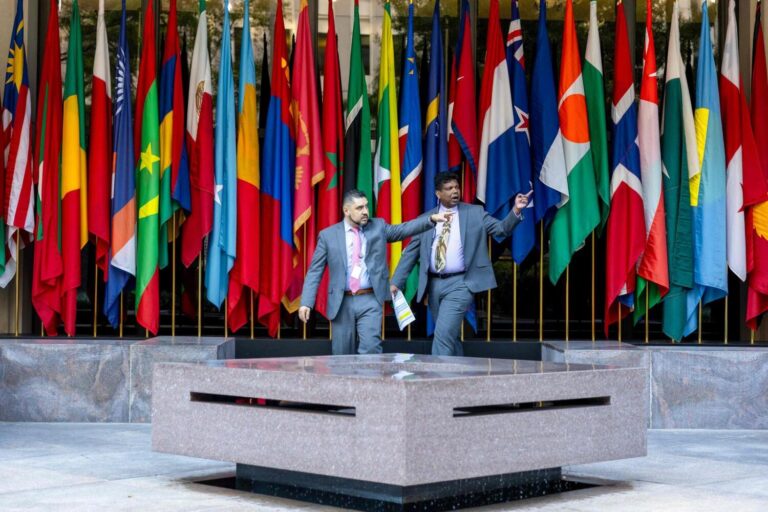 People gather outside World Bank headquarters during the first day of meetings of the IMF:World Bank on Monday in Washington, DC. — AFP